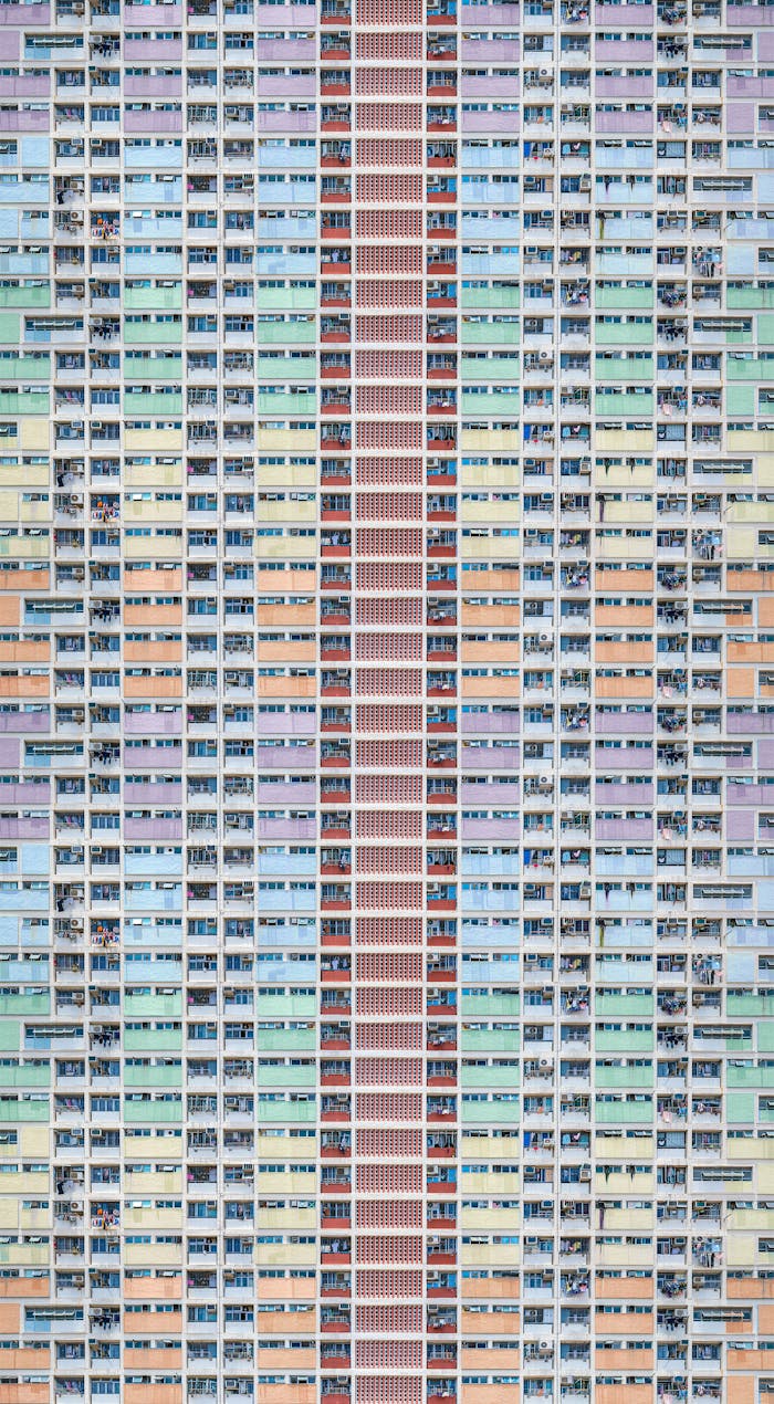 gallery-3 A colorful, modern residential building exterior in Hong Kong, emphasizing urban architecture.
